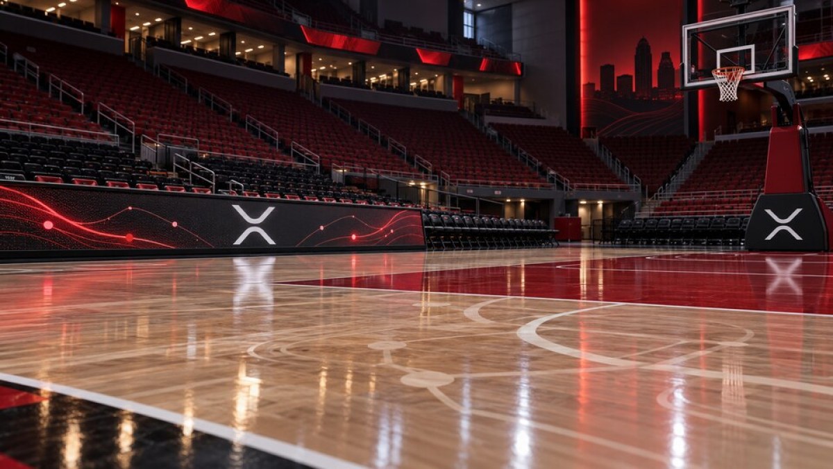 Conceptual editorial image of an empty red-and-black basketball arena with XRP symbols on courtside displays